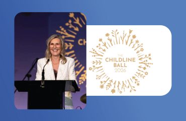 Woman speaking at Childline Ball 2026, charity event for children's welfare.
