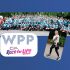 Large group of people in blue shirts at Race for Life charity event.