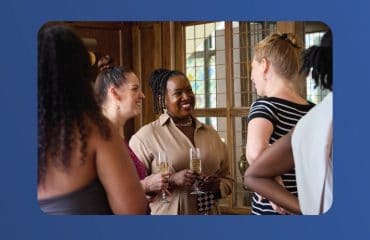 Group of diverse women engaging at Active International event in a bright room.